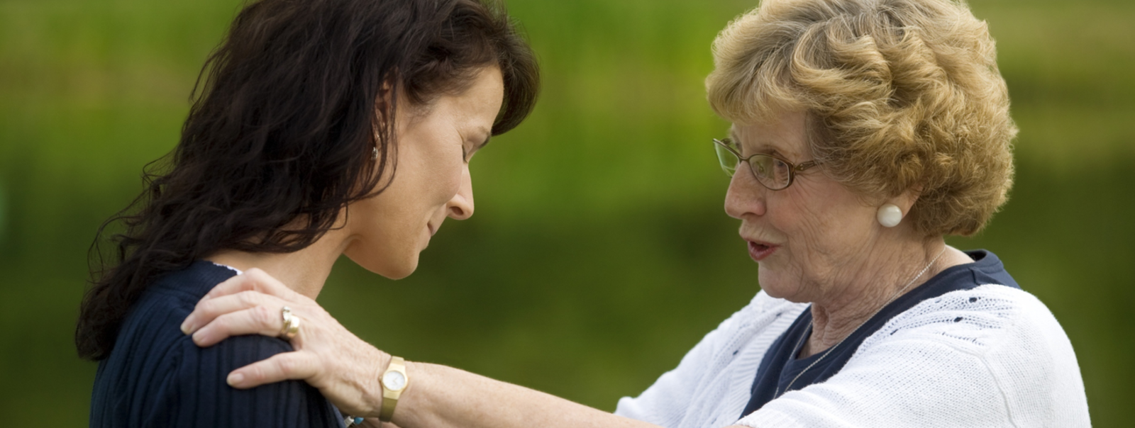 Two women comforting each other.