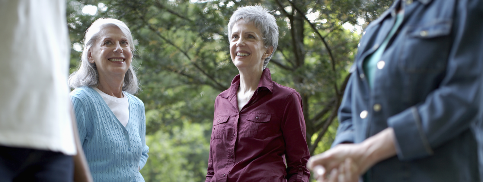 Women talking in an outdoor setting.
