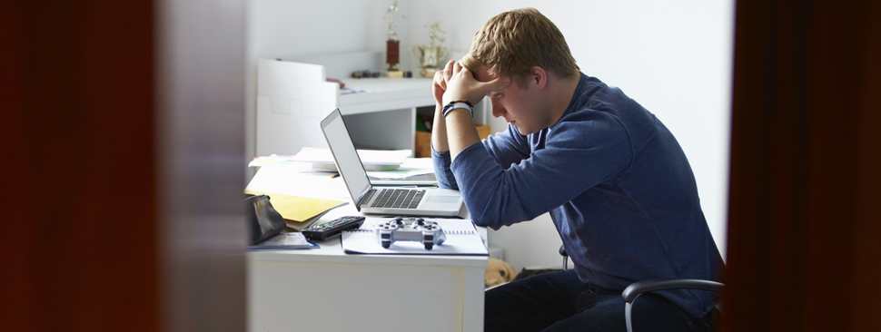 Teenager in distress at his desk